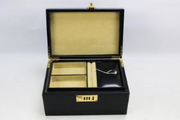 A black leather jewellery box with pull out compartment and combination lock