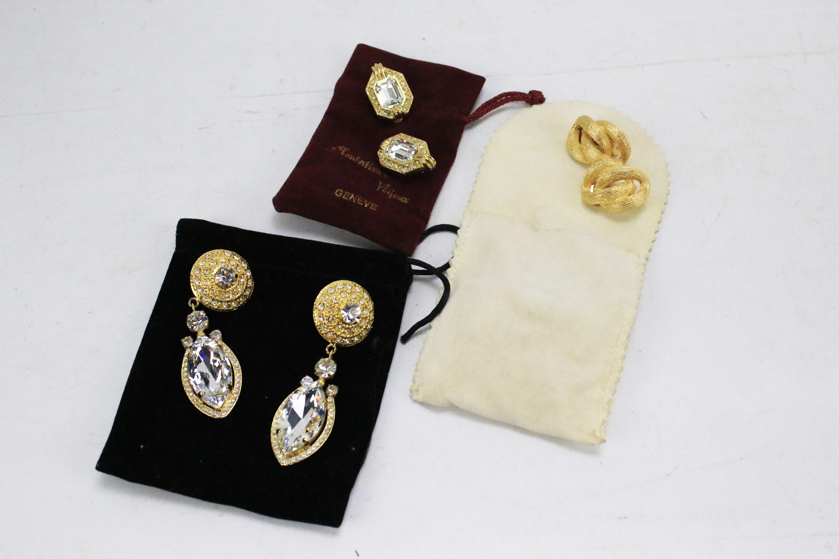Three pairs of designer earrings.
