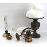 An oil lamp and a selection of related components.