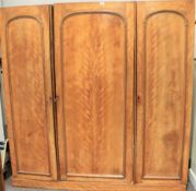 A large early 20th century wardrobe. WIth linen press, drawers and hanging space behind three doors.