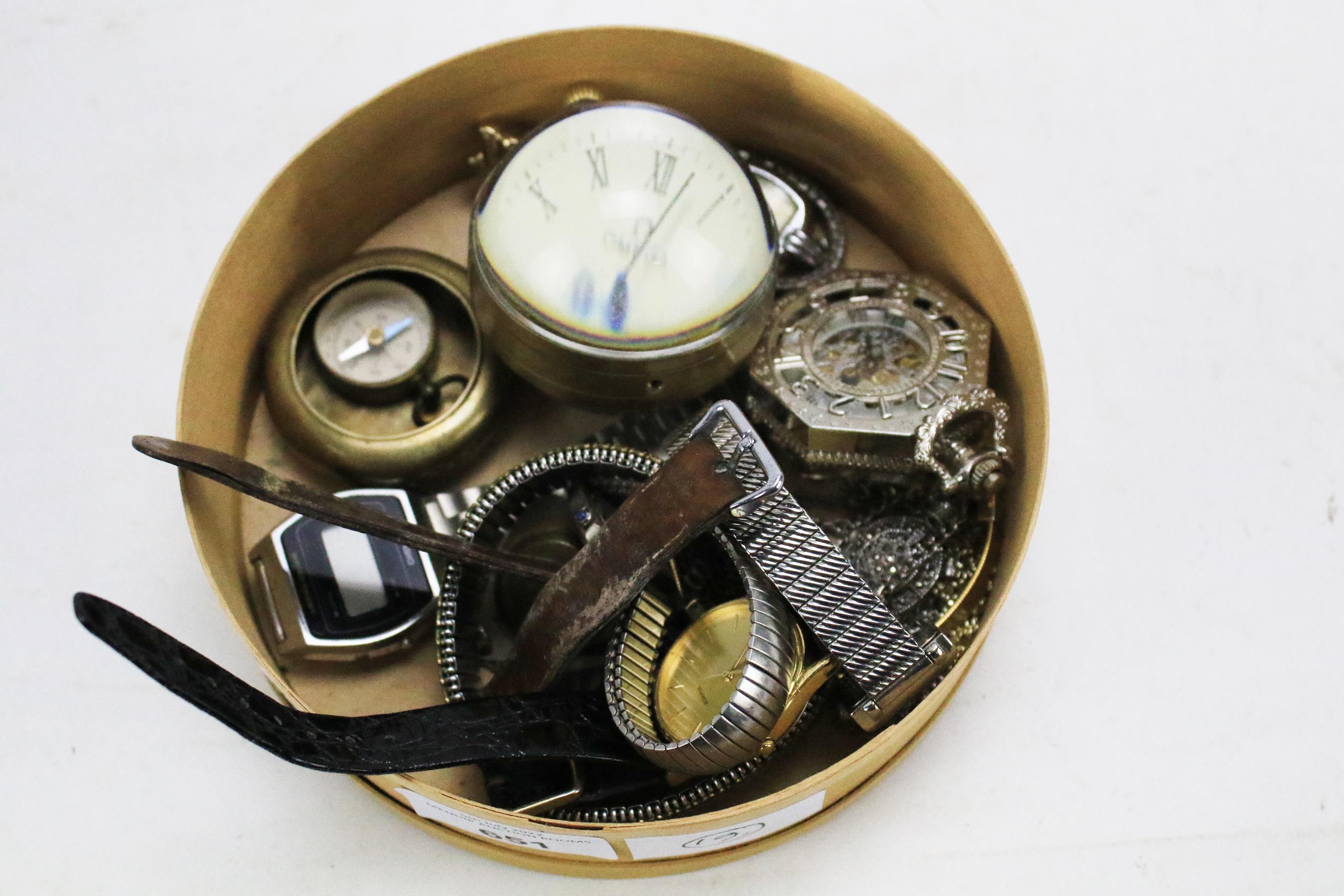 A box of vintage watches and a compass.