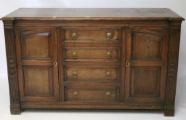 A 20th century carved oak sideboard.