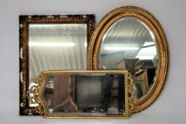 Three modern carved wood and giltwood mirror frames.
