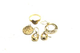 A pair of 9ct gold earrings, another single example, a St Christopher's pendant and other items.