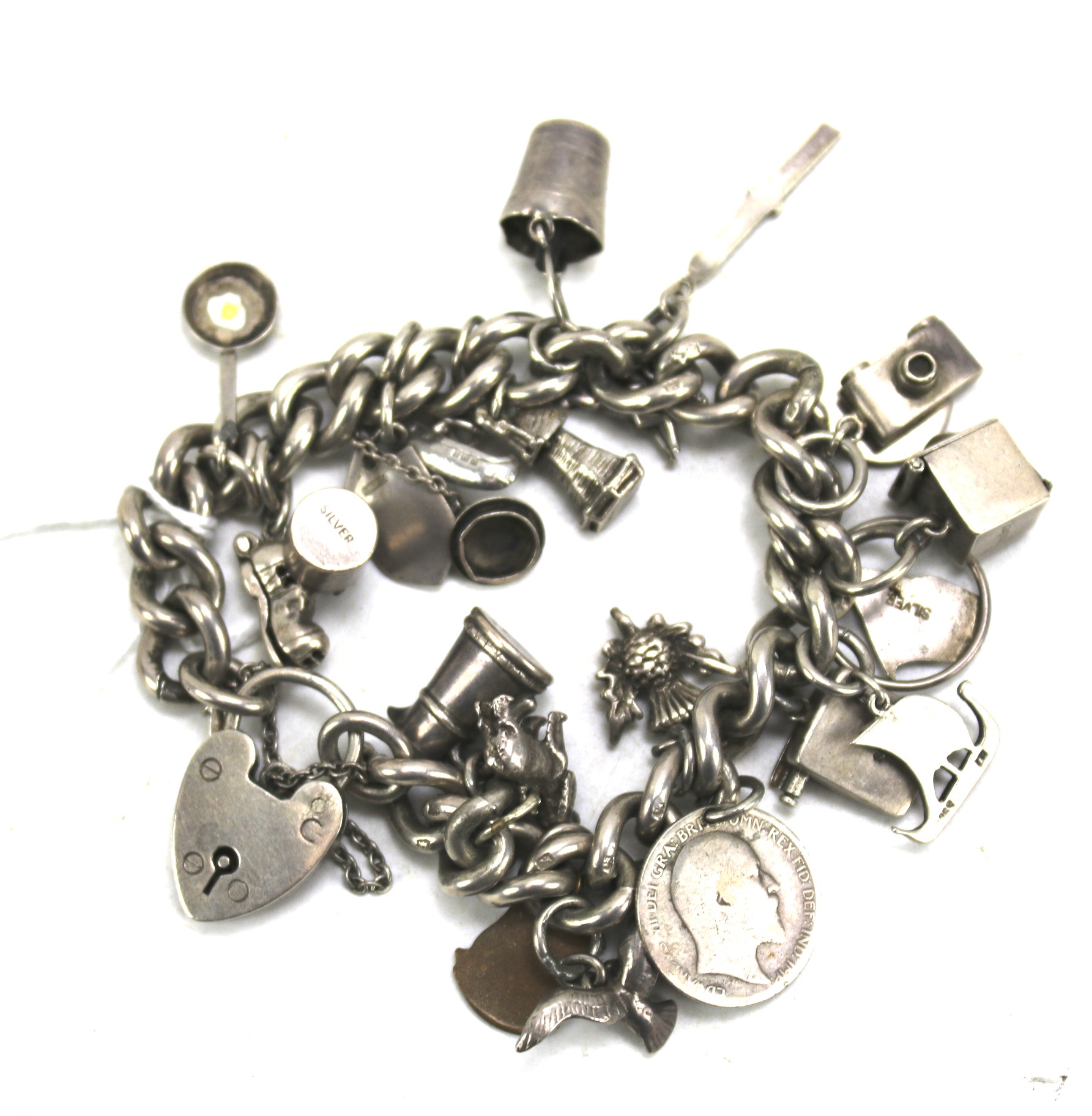 A silver charm bracelet with a heart padlock.