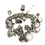 A silver charm bracelet with a heart padlock.