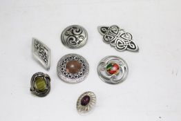 A collection of Celtic design pewter and white metal brooches.