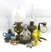 An assortment of glass, ceramics and oil lamps.