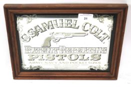 A vintage 'Samuel Colt patent repeating pistol' advertising wall mirror.