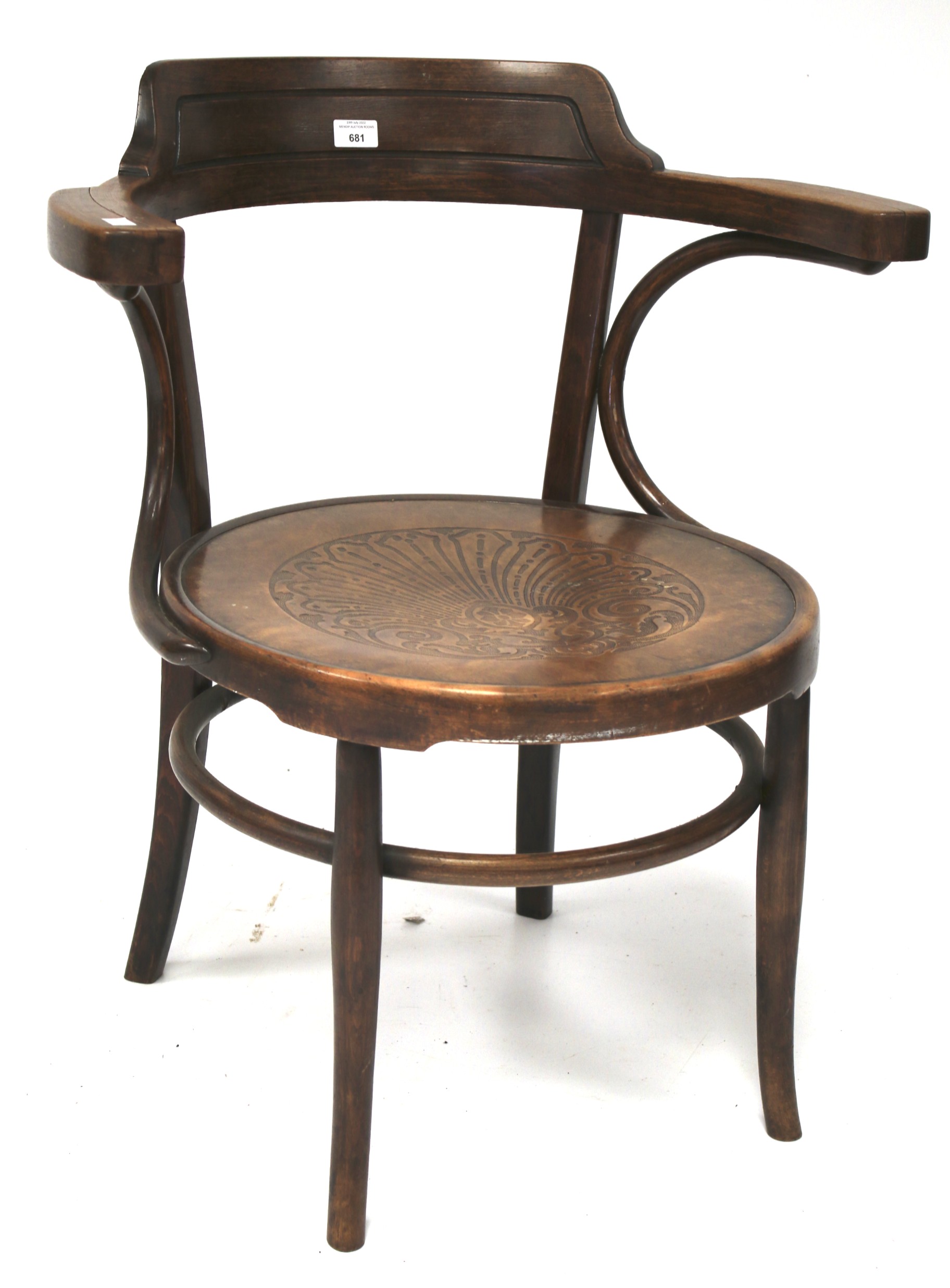 A bentwood elbow chair with carved decoration to the seat.