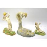 Three 20th century Art Deco Crown Devon figures of nude ladies and a young girl.