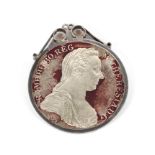 An Austrian Maria Theresa thaler coin, dated 1780. Mounted in white metal pendant stamped 'silver'.