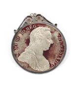 An Austrian Maria Theresa thaler coin, dated 1780. Mounted in white metal pendant stamped 'silver'.