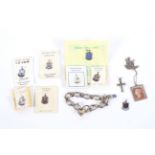 A silver charm bracelet, a silver mounted penny red pendant and assorted charms.