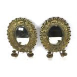 A pair of 20th century brass wall sconce mirrors.