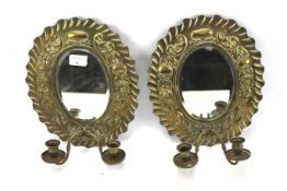 A pair of 20th century brass wall sconce mirrors.