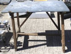 A hammered metal topped work bench.