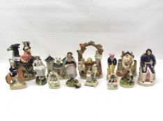 A collection of assorted Staffordshire figures.