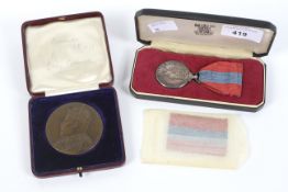 An Elizabeth II faithful service medal and an education medal.