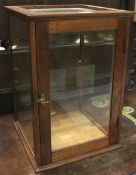 A wooden framed Dudley & Co table top display cabinet. L31.5cm x D31.