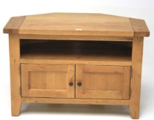 A contemporary oak corner tv unit.