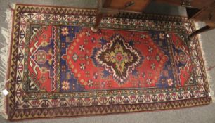 An Eastern woollen floor rug of geometric design.