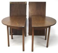 A contemporary mahogany extendable dining table.
