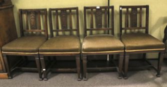 A set of four Arts and Crafts style dining chairs.