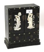 A Chinese mother of pearl inlaid jewellery cabinet.