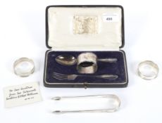 A pair of Georgian tongs, boxed christening set and two napkin rings.