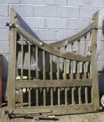 A pair of large oak garden gates, of sweeping form,