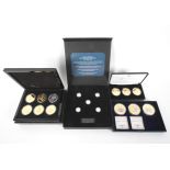 Four boxed sets of coins.