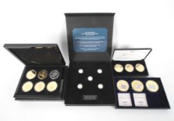 Four boxed sets of coins.