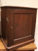 An Edwardian mahogany free standing smoker's cabinet. The single door enclosing a shelf and drawer.