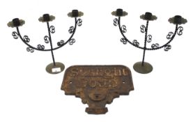 A vintage Sunlight Soap cast iron wall sign and two three sconce candelabra.