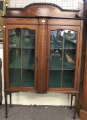 An early 20th century inlaid mahogany display cabinet.