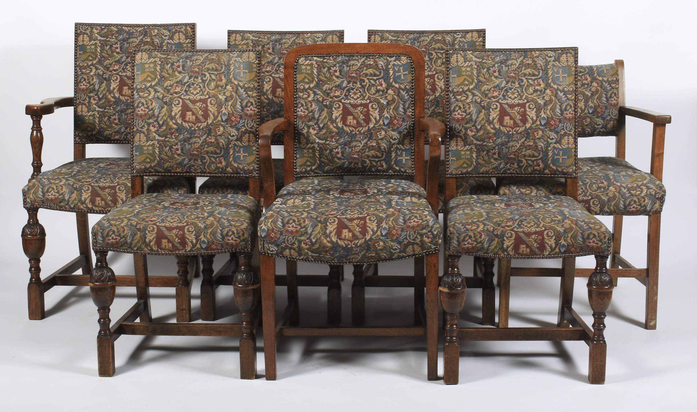 Seven Edwardian oak upholstered dining chairs.