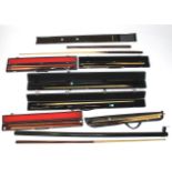 Eight snooker cues.