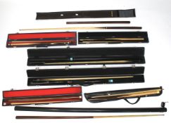 Eight snooker cues.