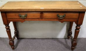 An early 20th century plank top walnut two drawer hall table.