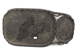 An unusually shaped carved wooden tray decorated with flowers and foliage.