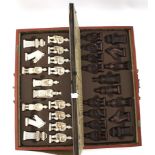 A 20th century oriental cased travelling chess set.