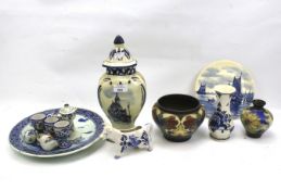 An assortment of Dutch Delftware and two Art Nouveau Gouda pottery vases.