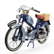 A vintage blue and chrome moped named 'Paloma' With white wall tyres and wicker basket to rear,