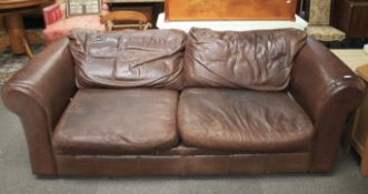 A brown leather three seater sofa.