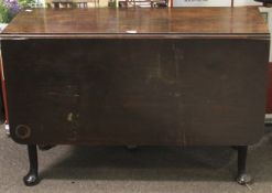 A Georgian mahogany drop leaf table. Raised on turned supports to pad feet.