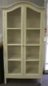 A large two door cream painted French kitchen parlour cupboard.