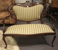 An Edwardian mahogany framed parlor sofa and occasional table.