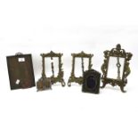 A collection of brass and metal mounted photograph frames.