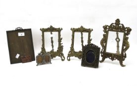 A collection of brass and metal mounted photograph frames.